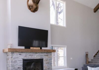 A Cozy Living Room with a Mounted Deer Head, Showcasing Remodeling Services in Menasha, WI