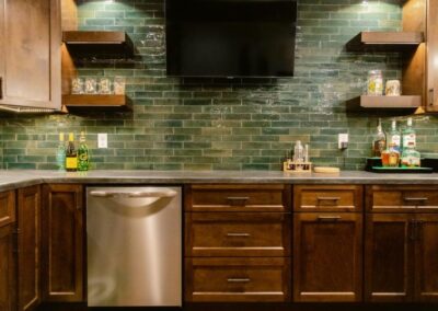 A Stylish Kitchen with a Green Tile and Wooden Cabinets, Showcasing Remodeling in Menasha, WI