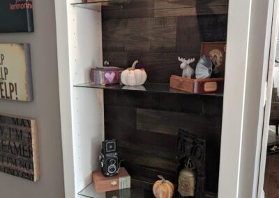 Stylish Bookcase with Glass Shelves and Wooden Wall, Showcasing Modern Design for Menasha, WI